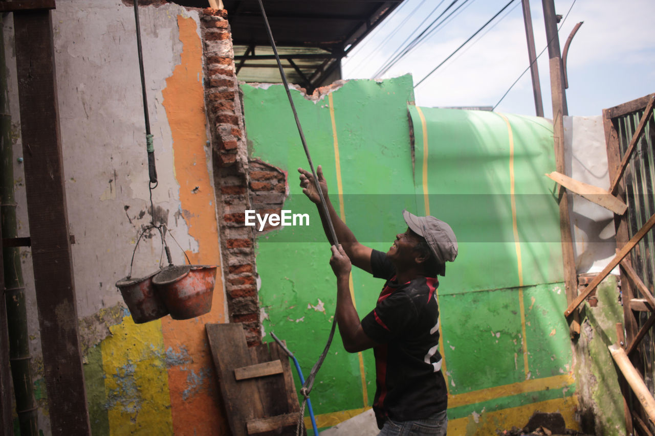 Rear view of man working at harbor