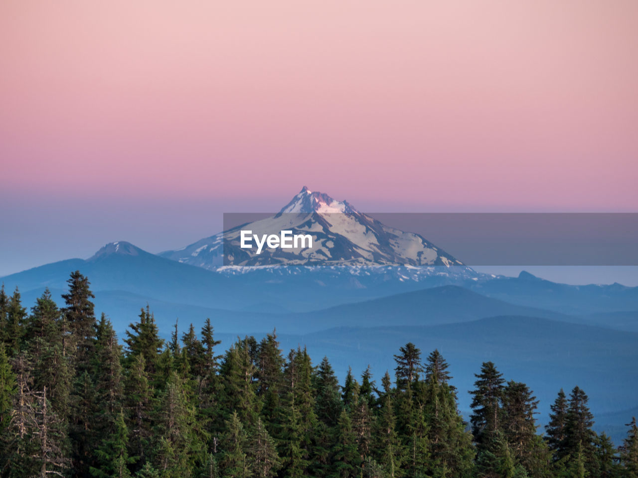 Scenic view of mountains against sky at sunset