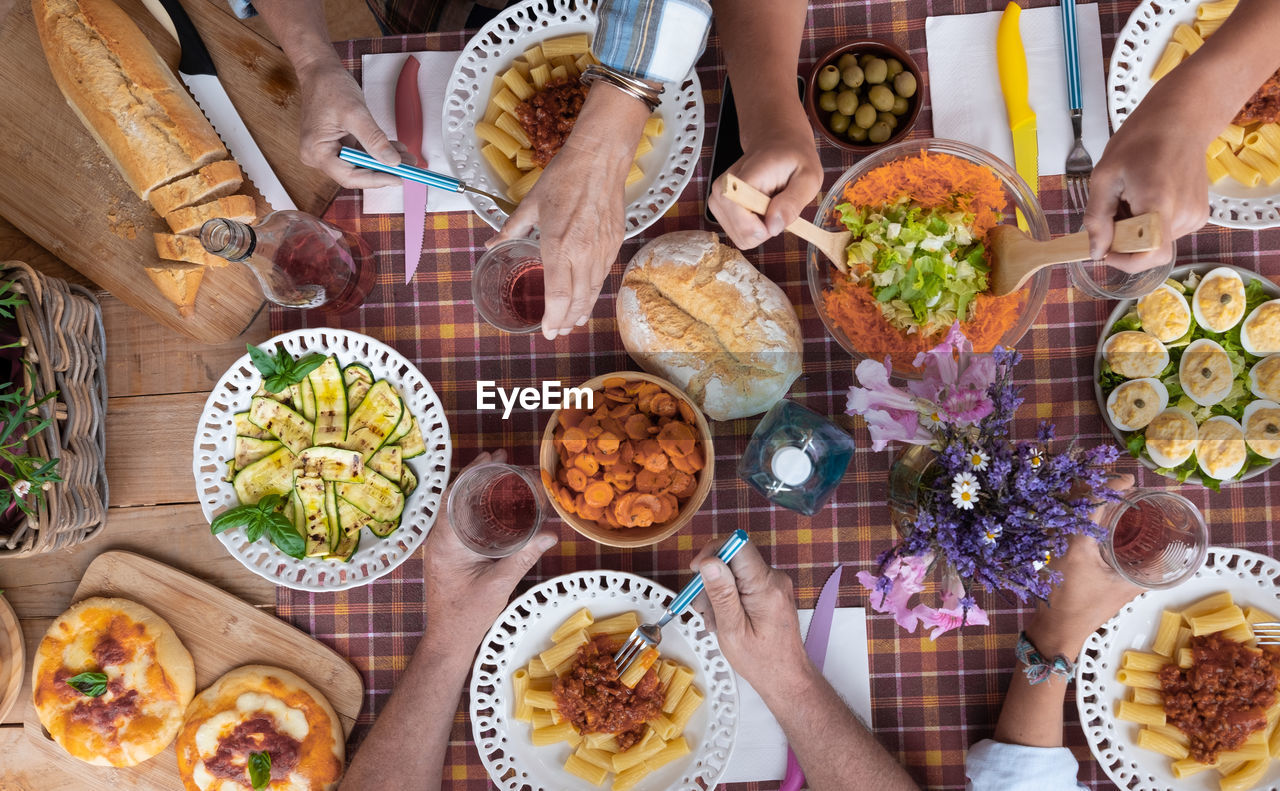 Cropped hands of people having food on table