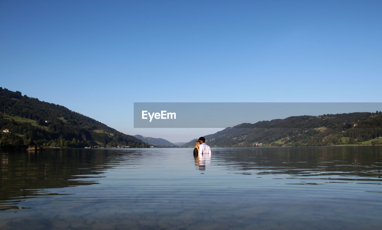 MAN IN BOAT AGAINST SKY