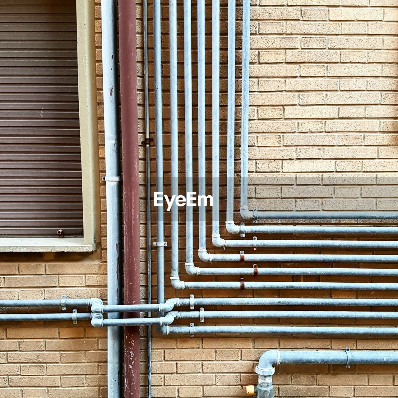 Pipelines on brick wall