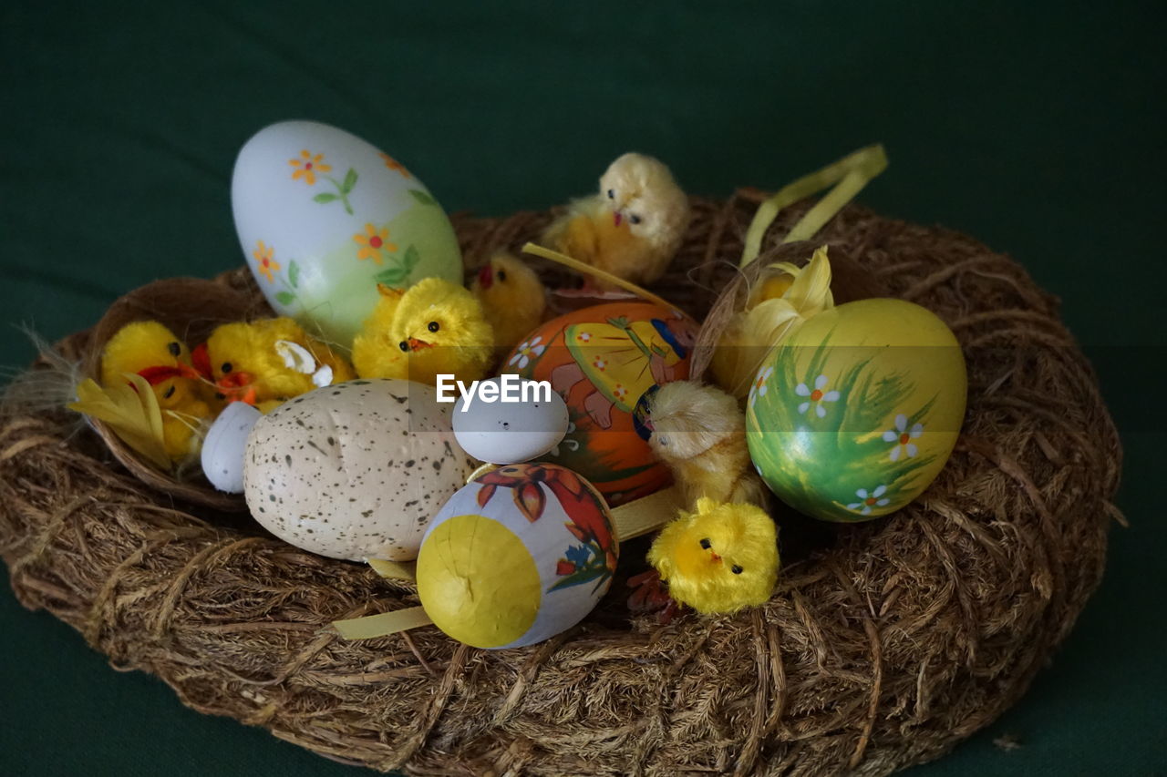 egg, easter, easter egg, tradition, celebration, holiday, animal nest, animal egg, food, basket, food and drink, bird, animal, no people, indoors, still life, decoration, studio shot, container, animal themes, multi colored, yellow, event, animal representation, nature, creativity, easter bunny, representation, close-up, group of objects, eggshell, religion, high angle view