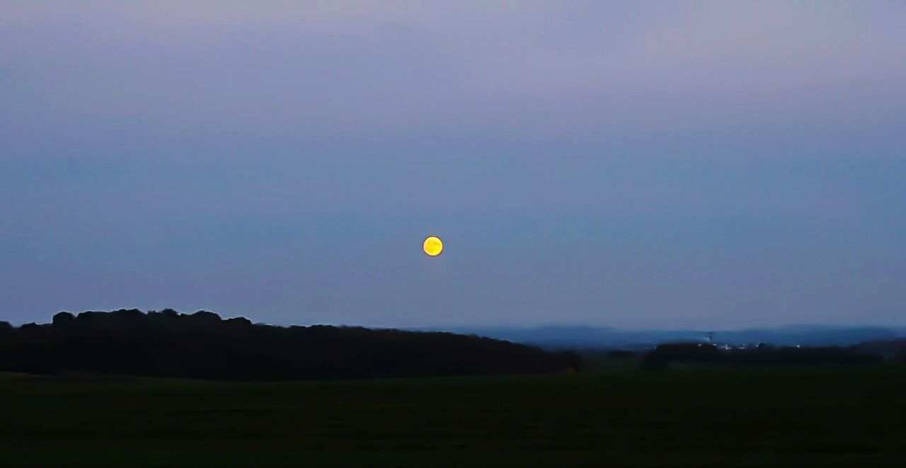 SCENIC VIEW OF MOON OVER LANDSCAPE AGAINST SKY