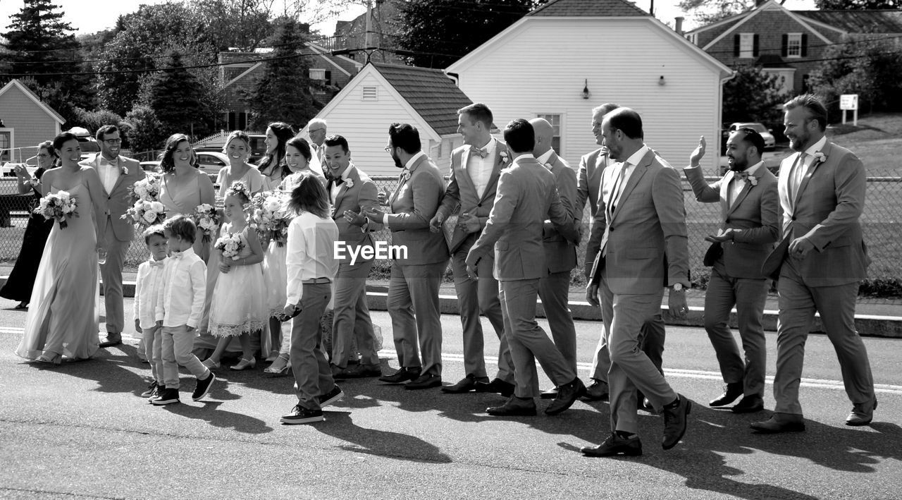 GROUP OF PEOPLE IN FRONT OF AN ANIMAL