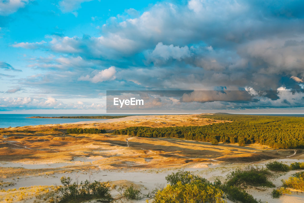 SCENIC VIEW OF LAND AGAINST SEA