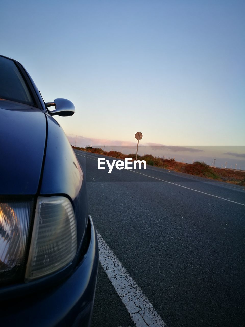 CAR AGAINST SKY AT SUNSET