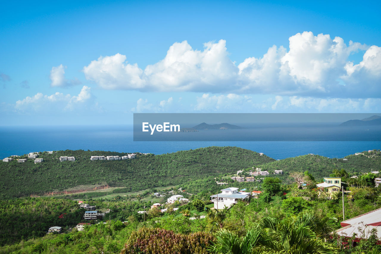 High angle view of townscape by sea against sky