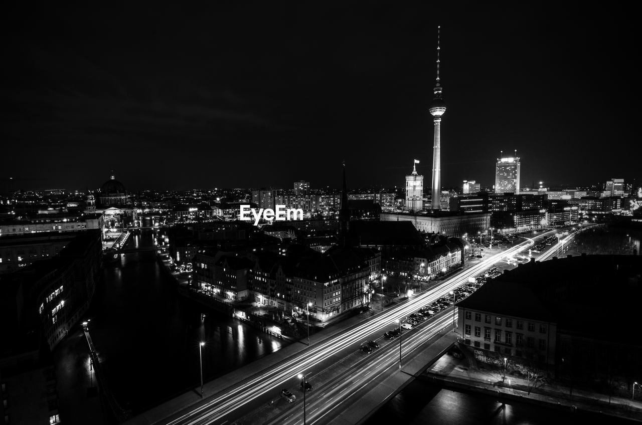 High angle view of city lit up at night