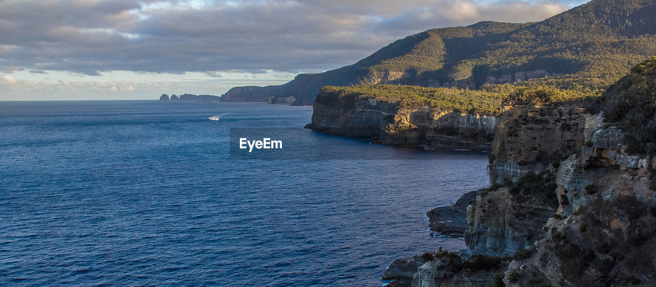 SCENIC VIEW OF SEA AGAINST ROCK FORMATION