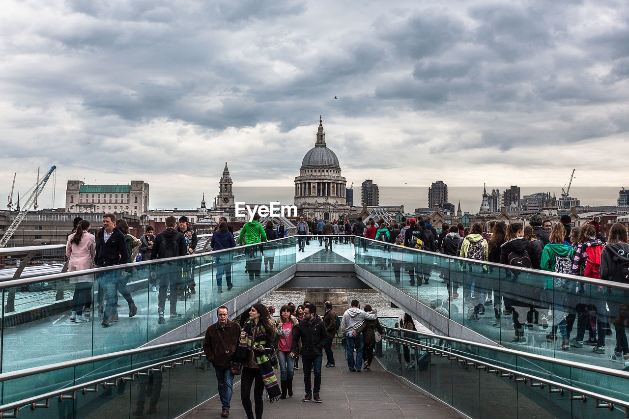 People walking on milennium bridge against st. paul's cathedral