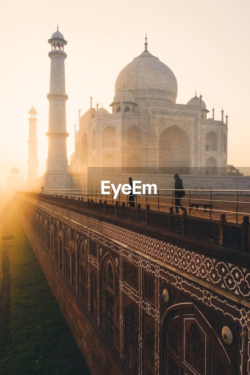 Tourist visiting taj mahal during sunrise