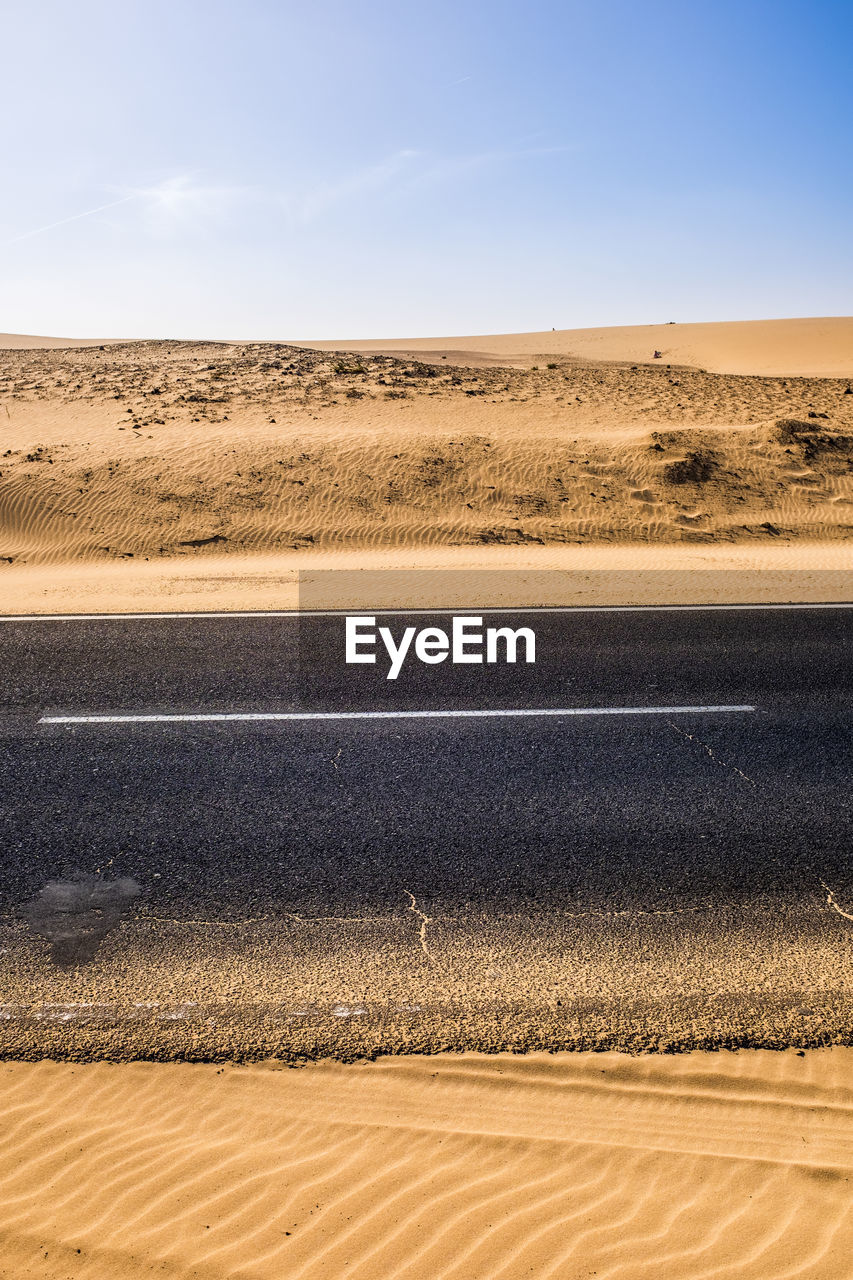 High angle view of road at desert against clear sky