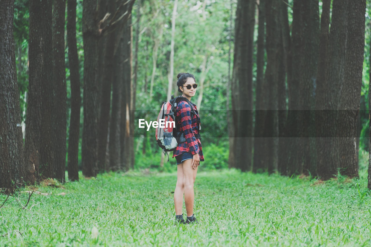 Portrait of woman standing in forest