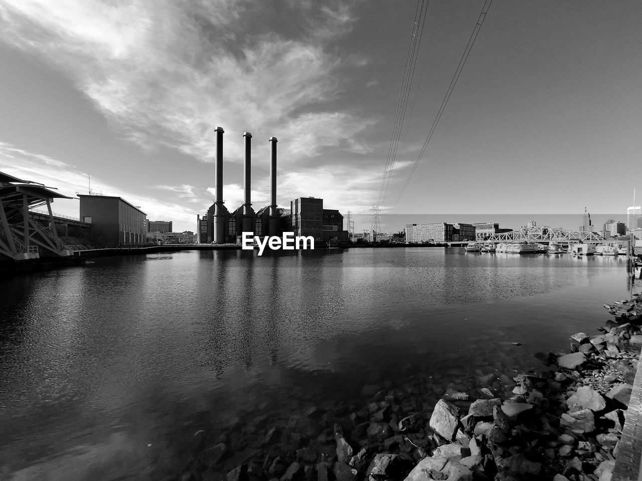 River by buildings against sky