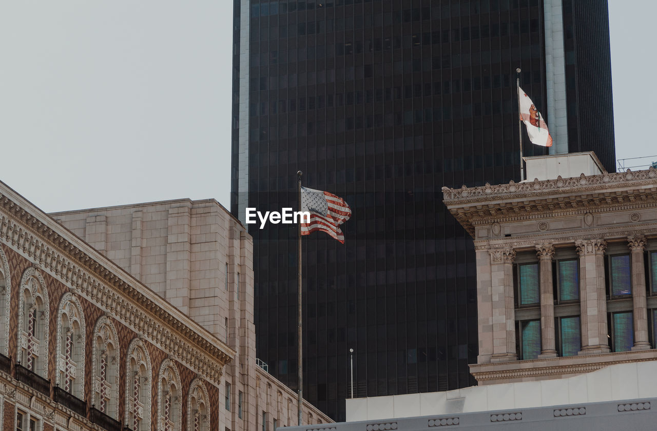 Low angle view of flags against buildings