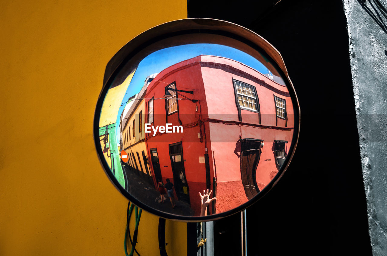 Reflection of buildings in road mirror