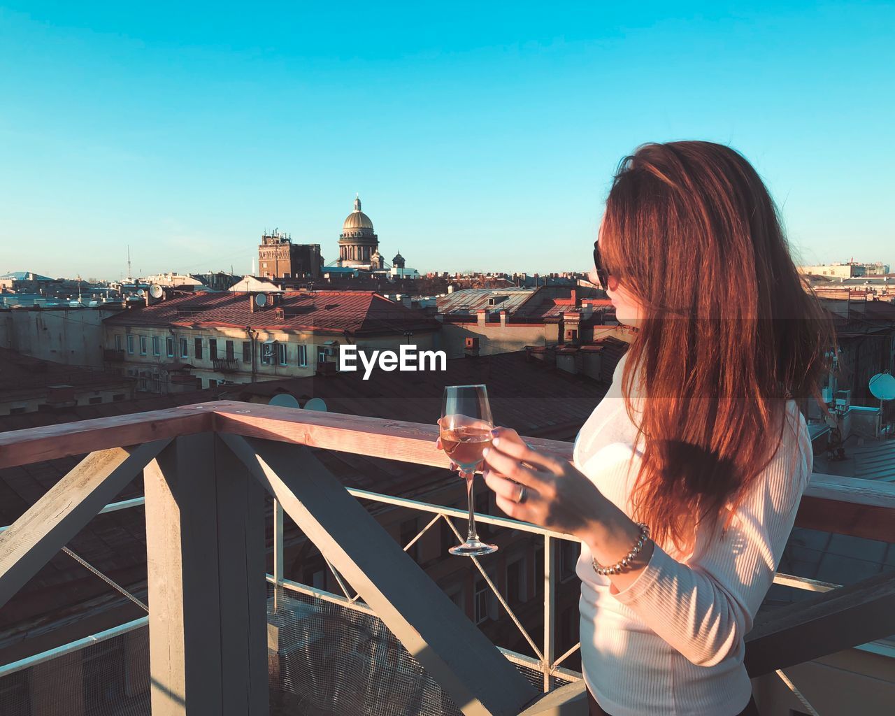 Woman having wine in city