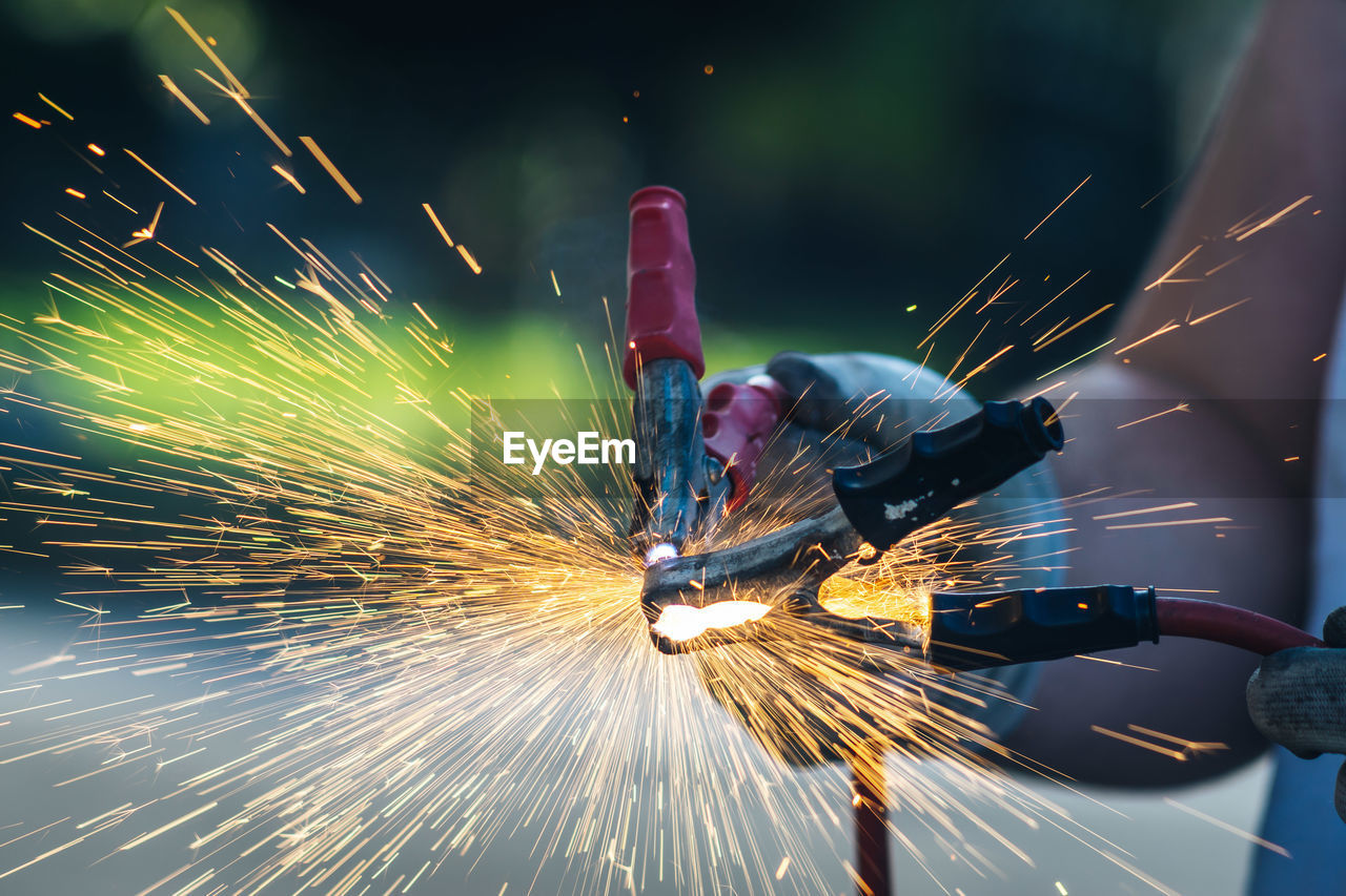 LOW ANGLE VIEW OF PERSON WORKING AT METAL STRUCTURE