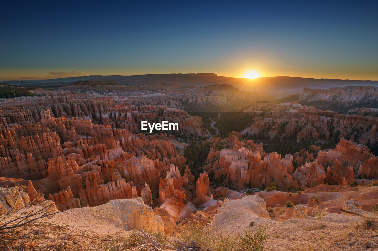 Scenic view of sunset over rock formations