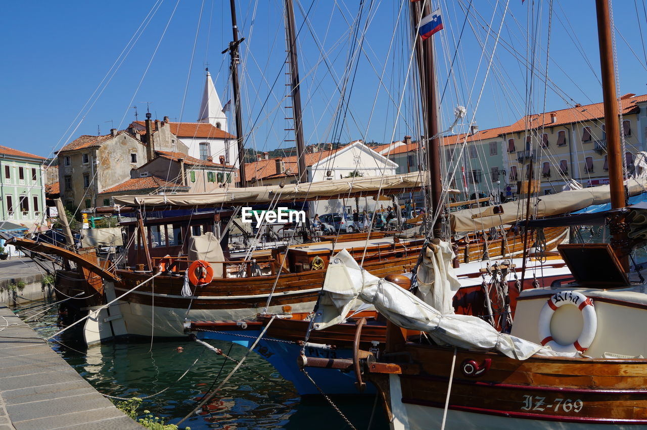 BOATS MOORED AT HARBOR