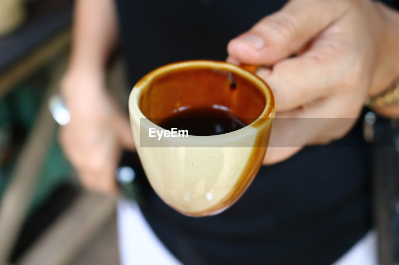 Cropped image of man holing espresso cup