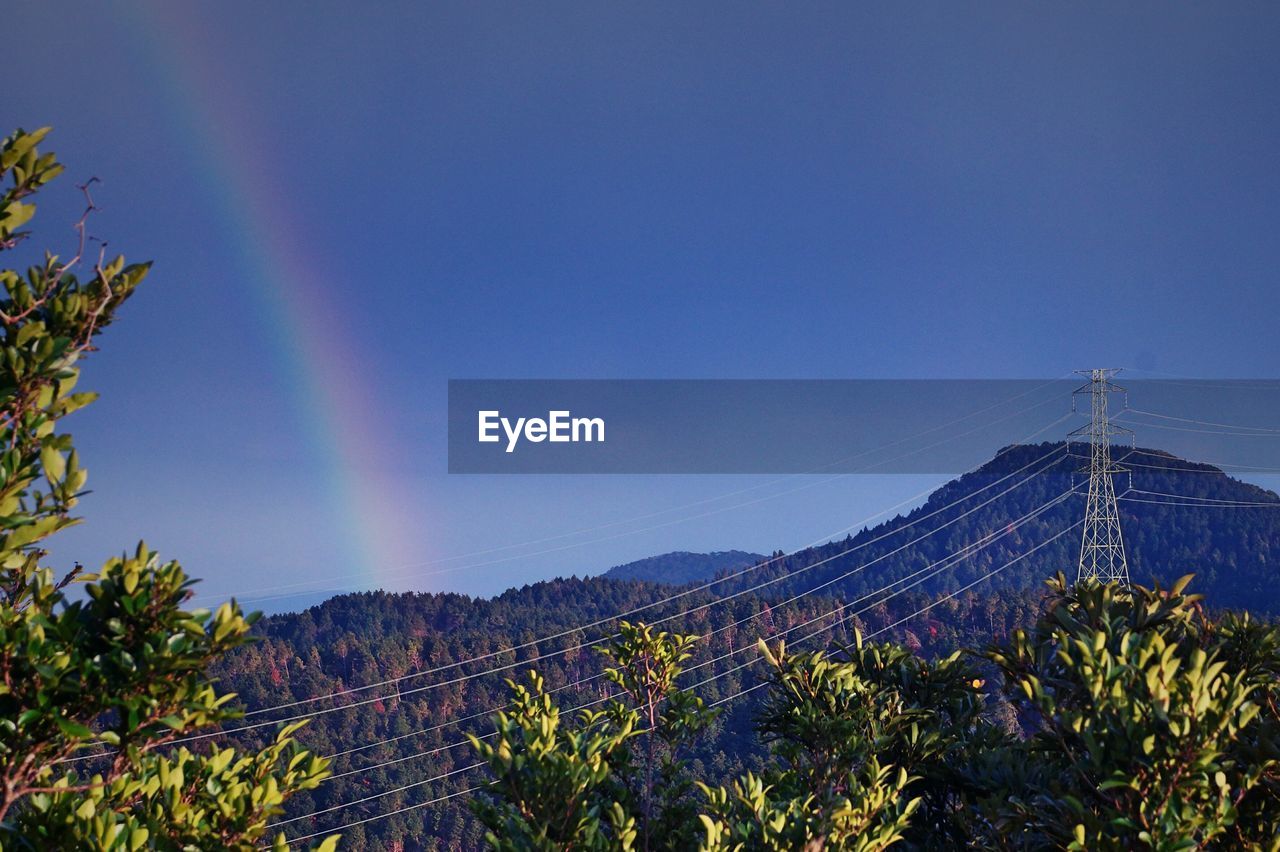 Low angle view of mountain against blue sky