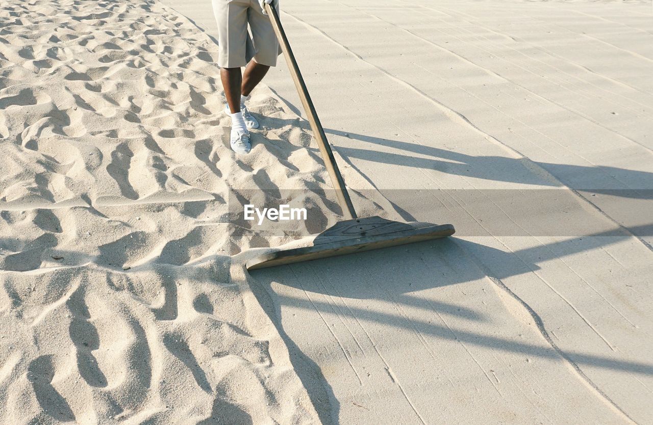 LOW SECTION OF MAN ON SAND