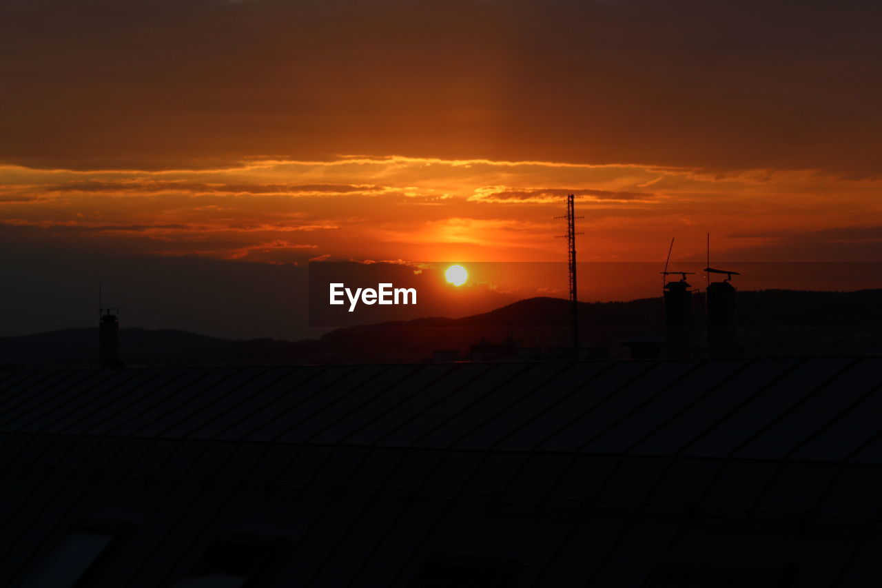 Silhouette land against sky during sunset