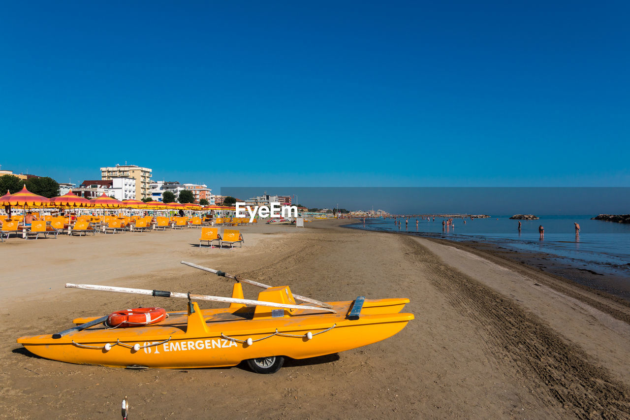 Scenic view of beach against clear blue sky