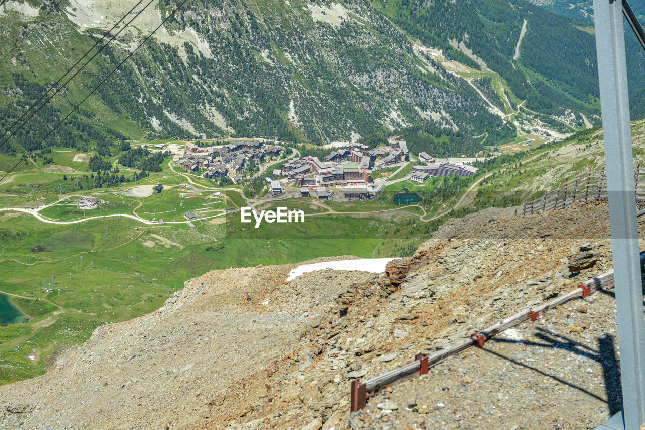 day, nature, aerial photography, high angle view, mountain, no people, beauty in nature, landscape, scenics - nature, land, mountain range, environment, mountain pass, built structure, tranquility, tranquil scene, plant, outdoors, architecture, sunlight, green, non-urban scene, transportation, tree