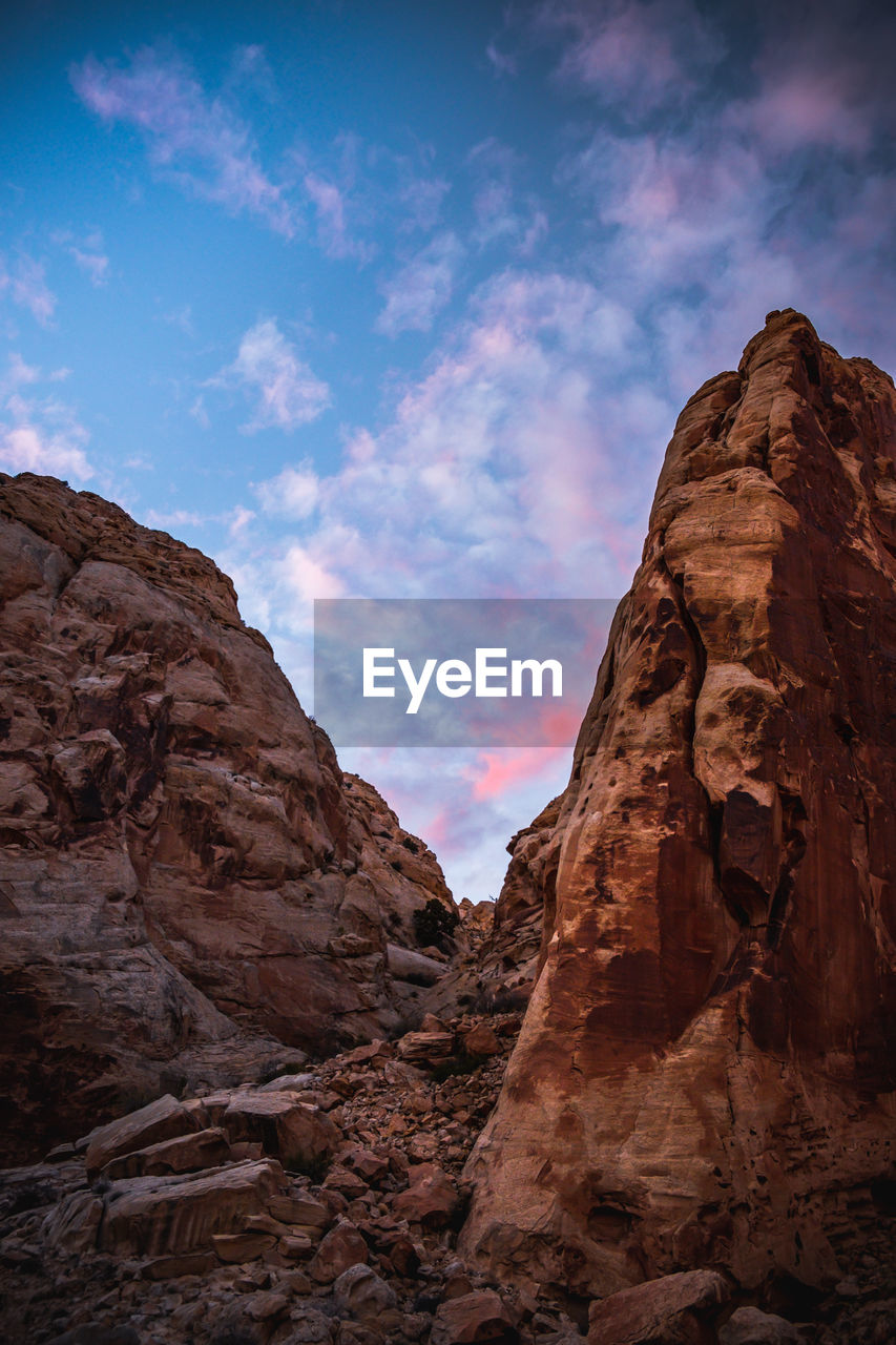 Low angle view of rock formation against sky