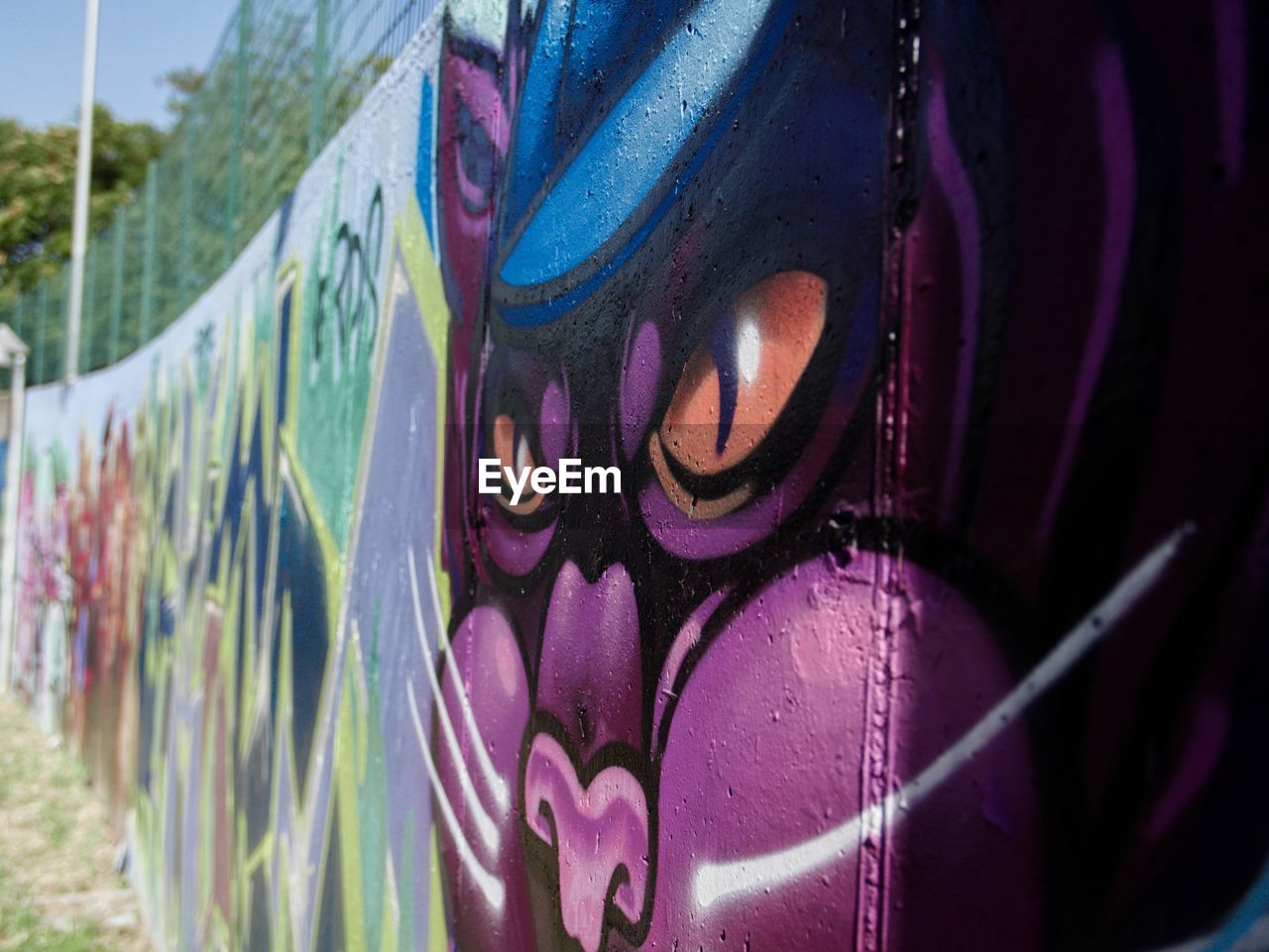 multi colored, creativity, purple, day, graffiti, close-up, no people, art, outdoors, representation, focus on foreground, nature