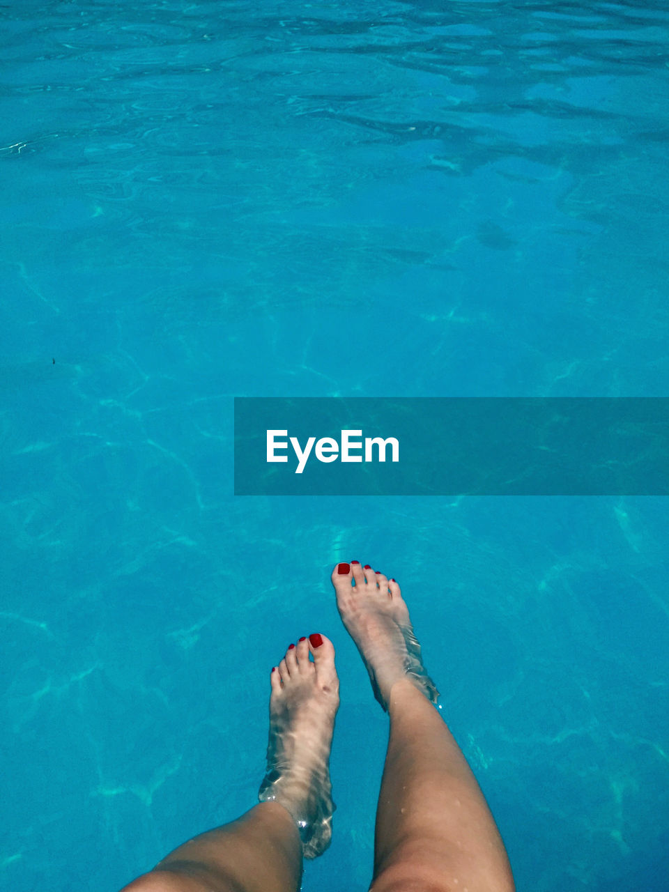 Low section of woman in swimming pool