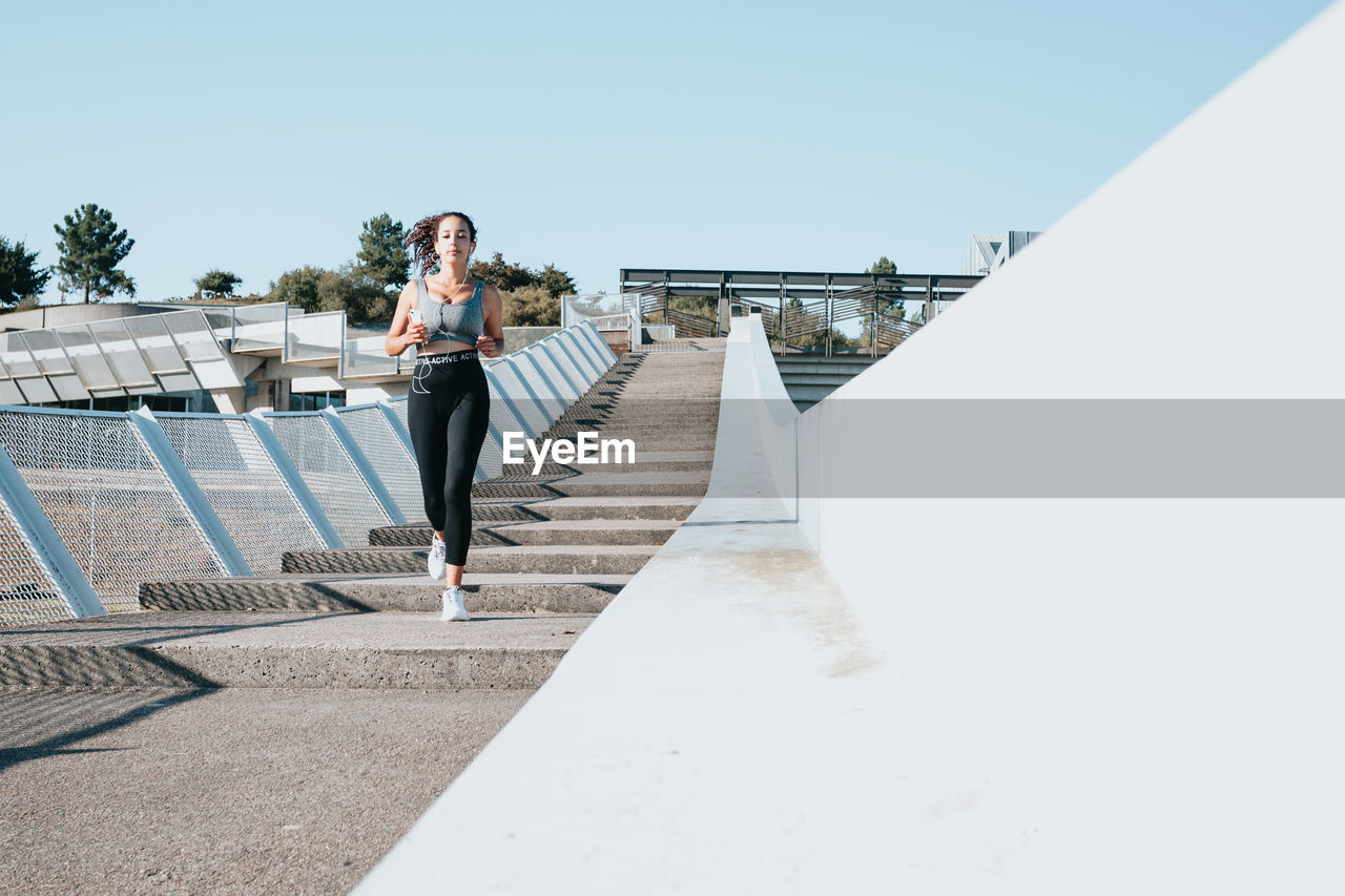 Female athlete running on steps