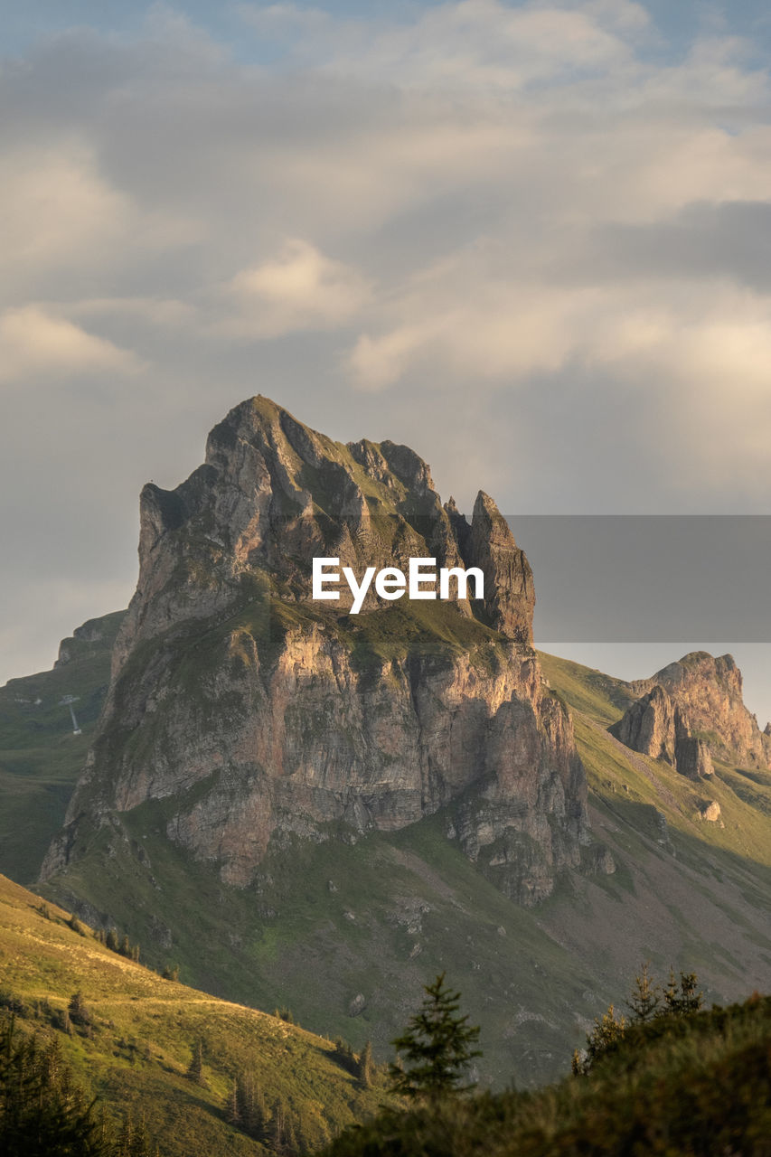 Scenic view of mountains against cloudy sky