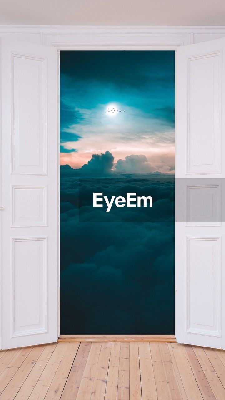 Scenic view of blue sky seen through open door