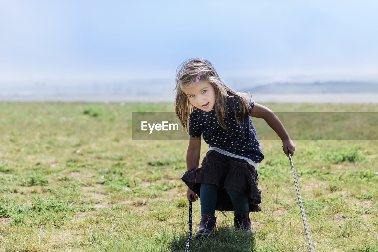 Full length of girl playing on grass outdoors