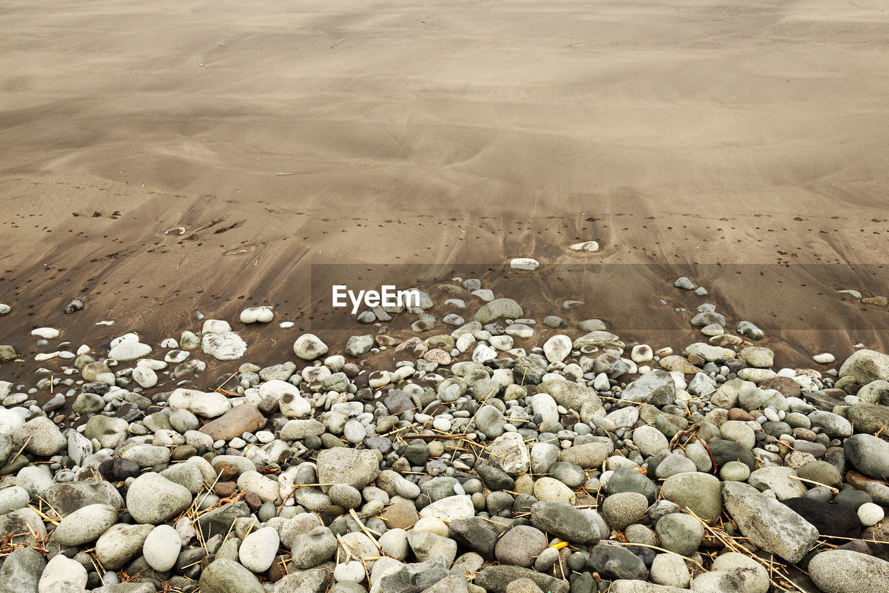 High angle view of stones on sea shore