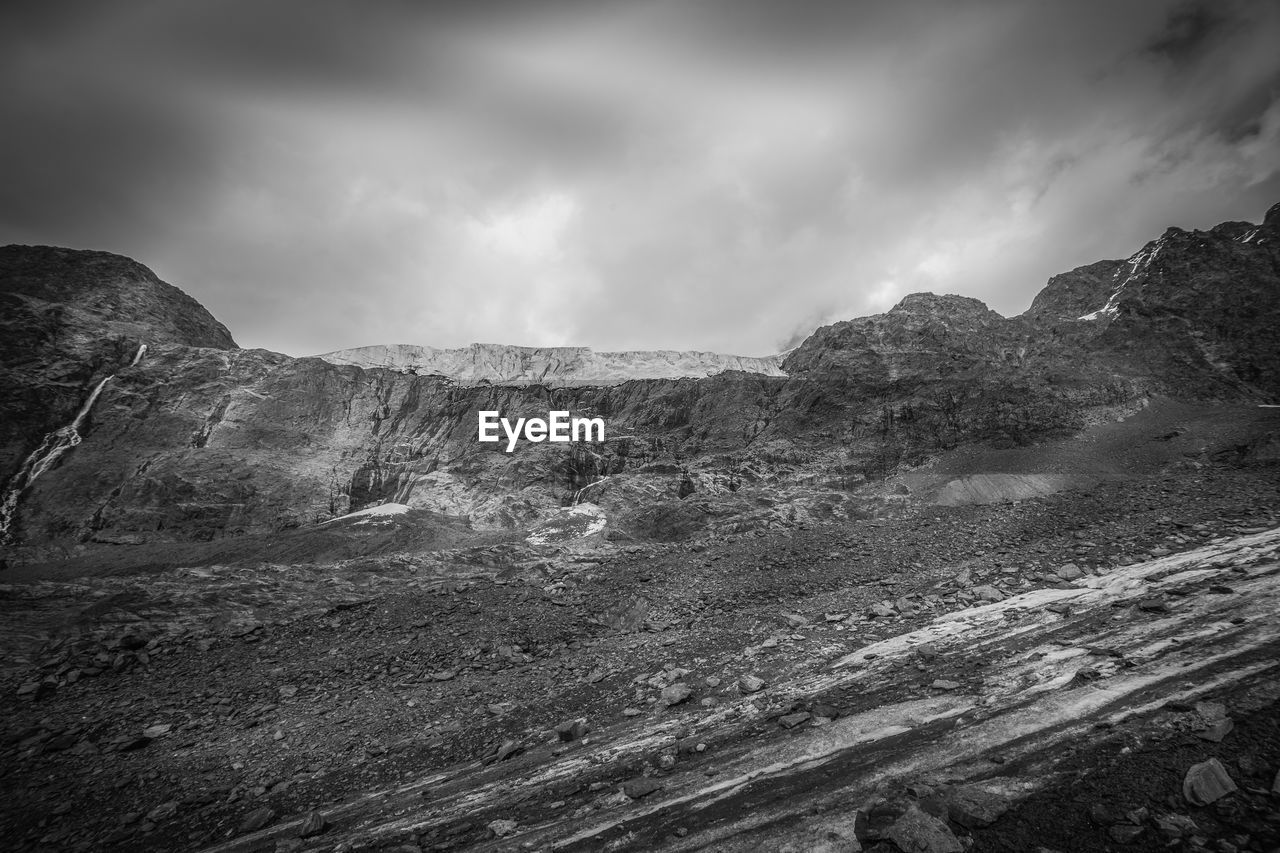 environment, cloud, black and white, landscape, sky, darkness, monochrome, mountain, rock, monochrome photography, scenics - nature, nature, beauty in nature, land, no people, non-urban scene, outdoors, mountain range, dramatic sky, travel destinations, travel, black, overcast, tranquility, storm, extreme terrain, snow, dramatic landscape