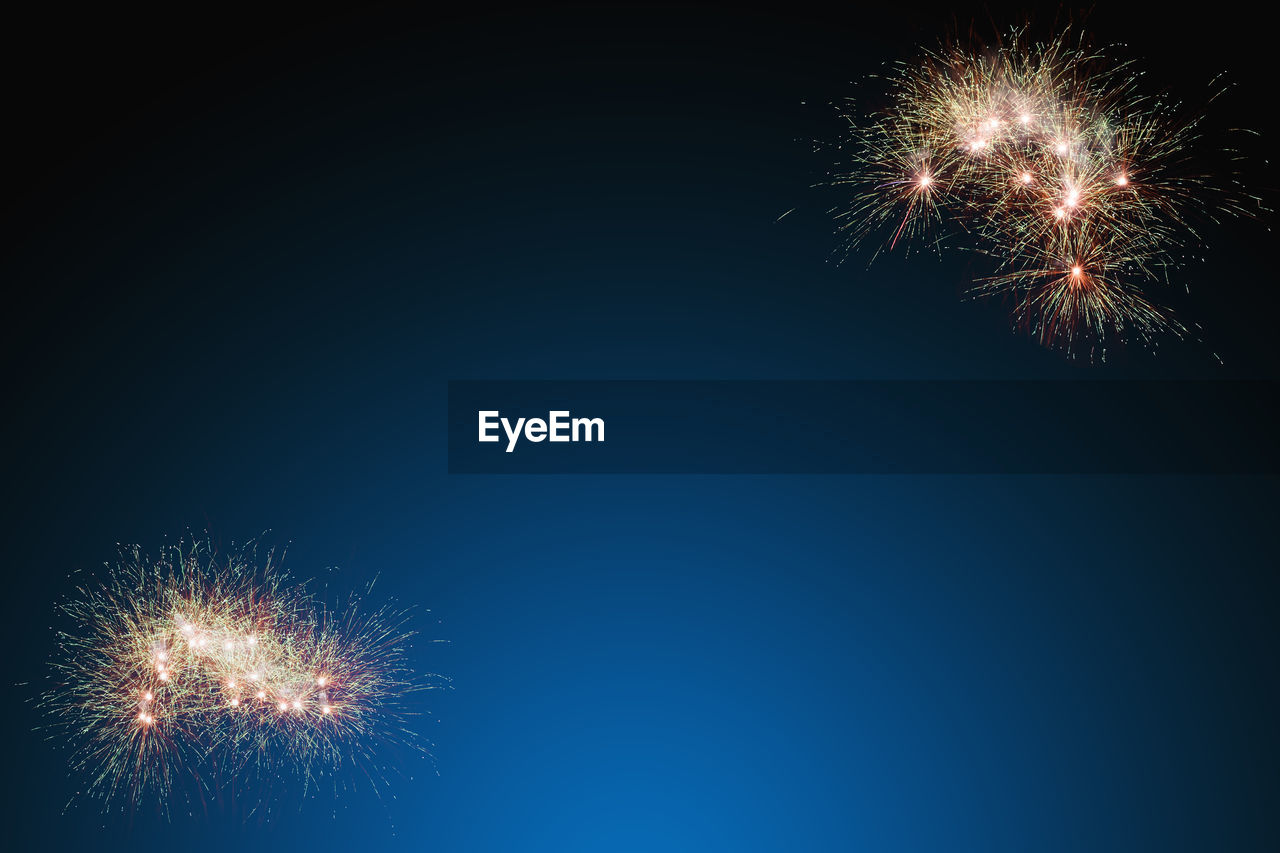 LOW ANGLE VIEW OF FIREWORK DISPLAY