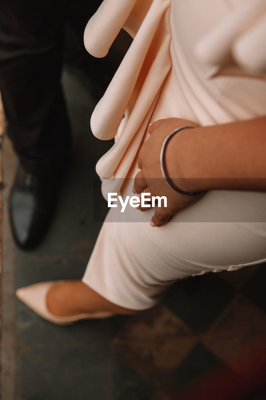 human leg, adult, women, limb, low section, shoe, human limb, sitting, footwear, one person, indoors, clothing, hand, fashion, lifestyles, human foot, female, finger, young adult, arm, high heels, focus on foreground, close-up
