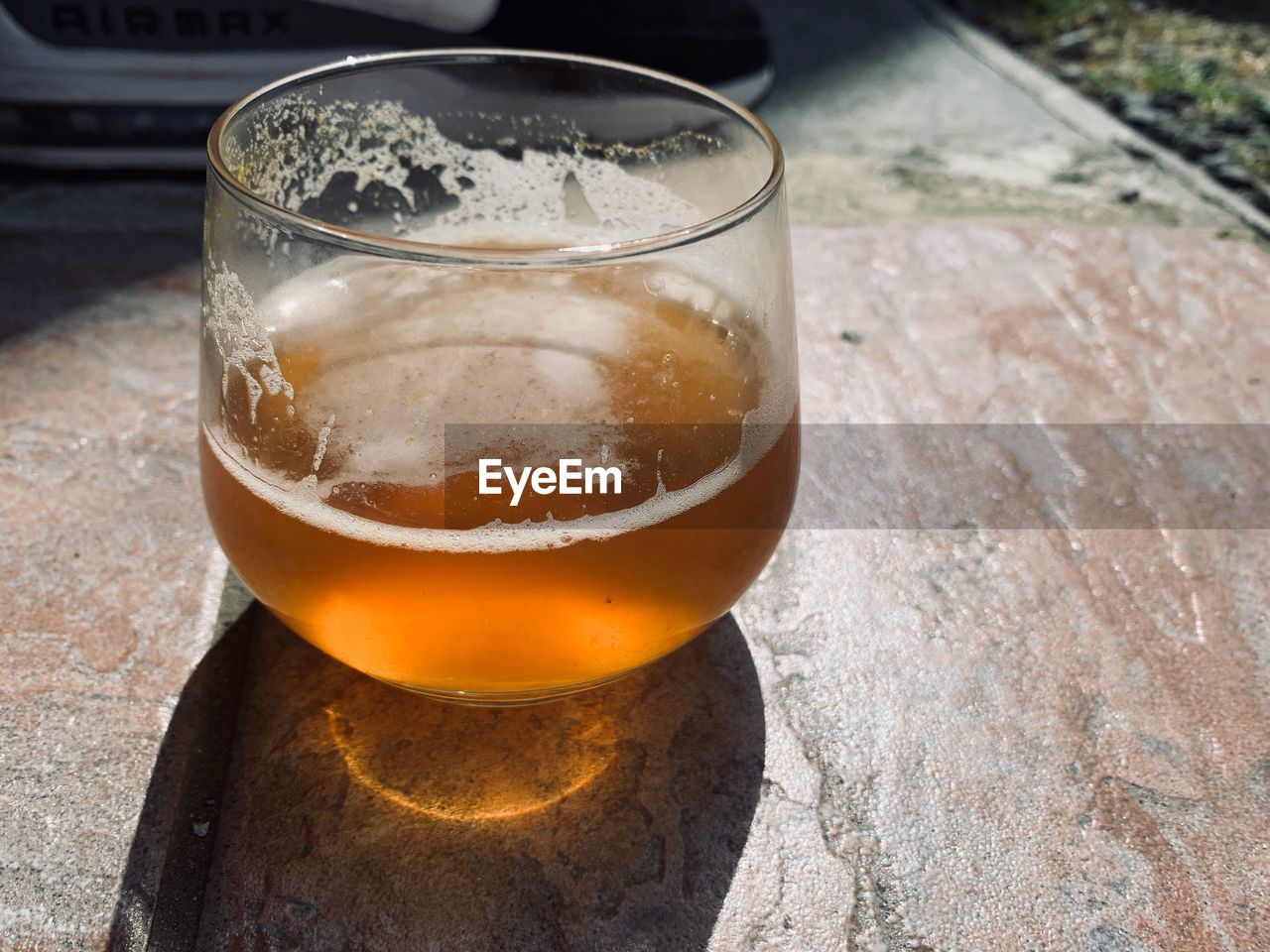 CLOSE-UP OF BEER ON GLASS TABLE