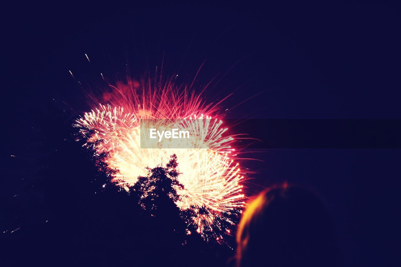 LOW ANGLE VIEW OF FIREWORK DISPLAY