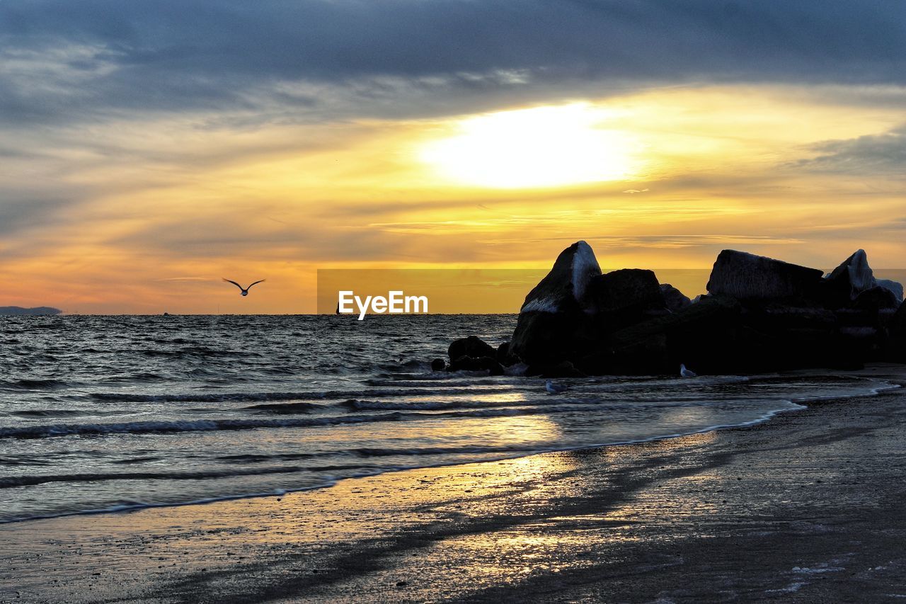 Scenic view of sea against sky during sunset