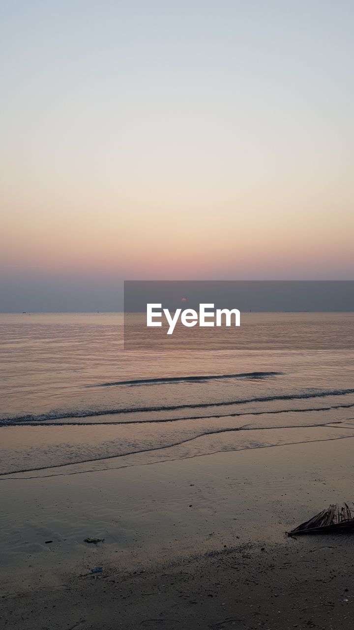 SCENIC VIEW OF BEACH DURING SUNSET