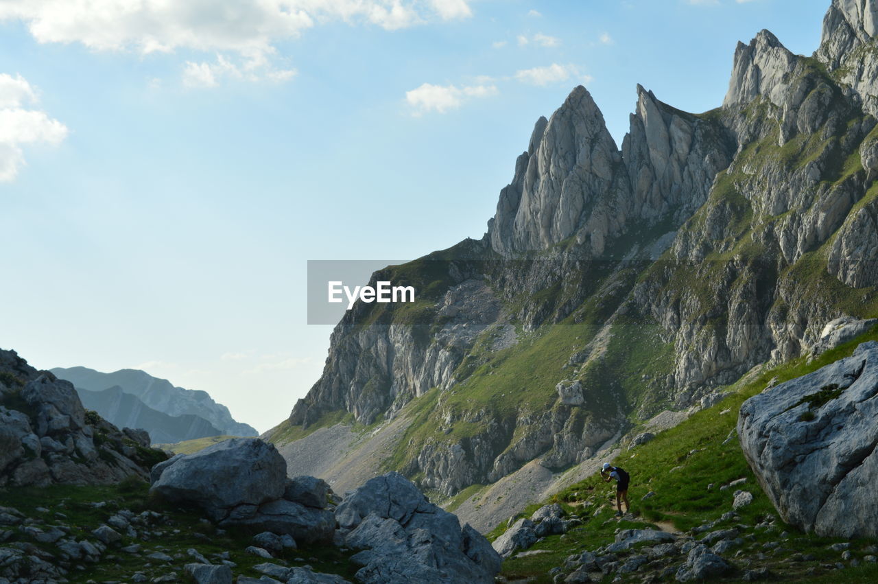 Scenic view of mountains against cloudy sky