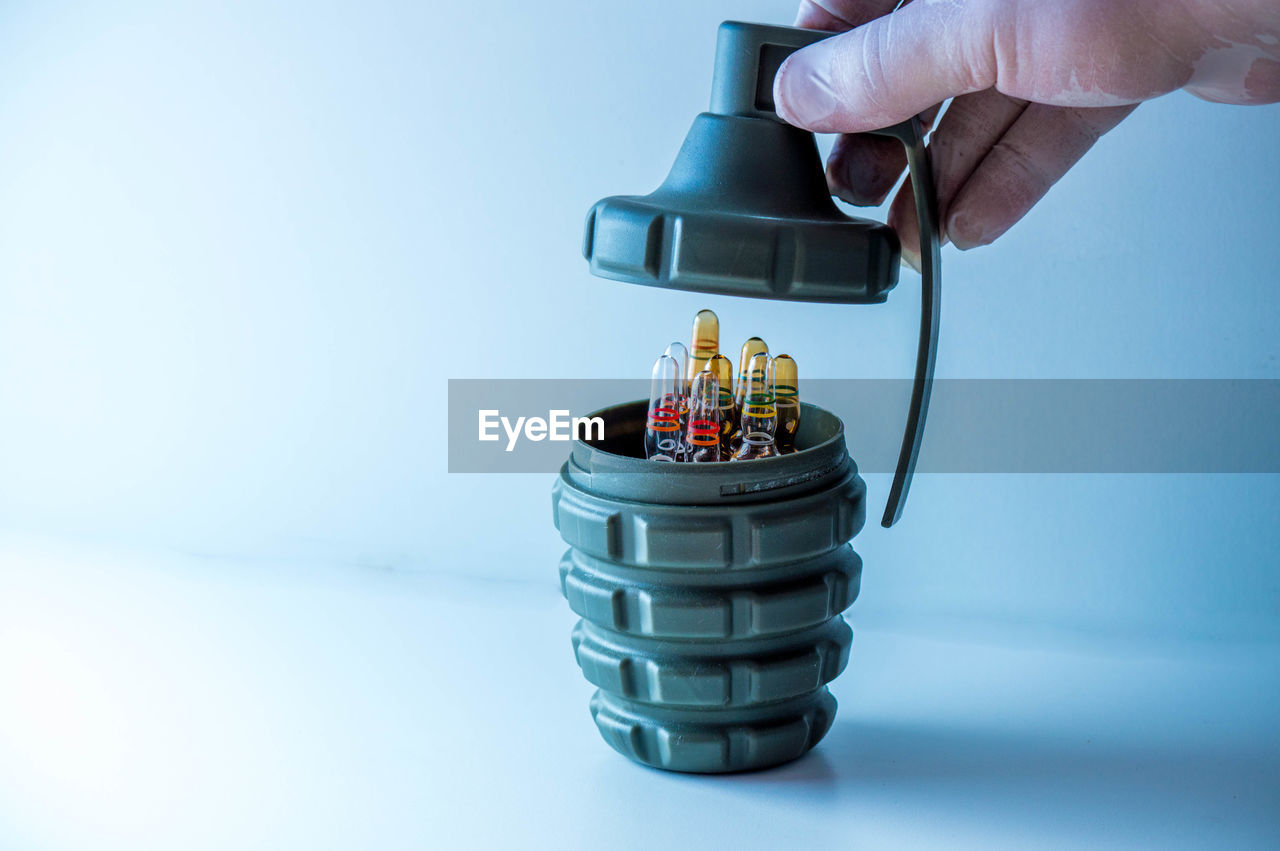 hand, one person, holding, indoors, adult, studio shot, business, technology, business finance and industry, occupation