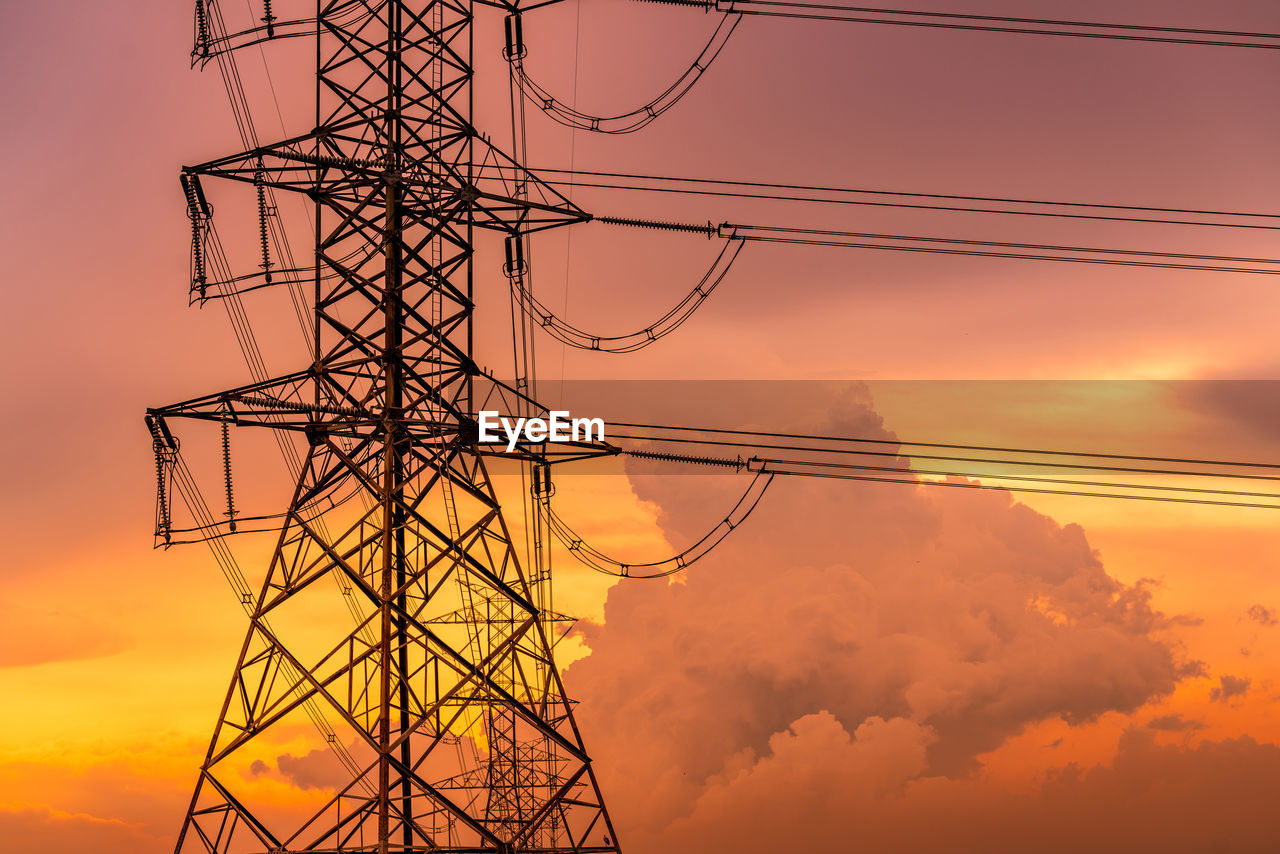 High voltage electric pylon and electrical wire with sunset sky. electricity pole. power and energy.