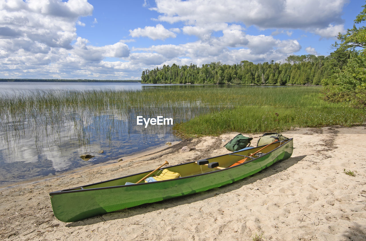 Loading the canoe on the shore of basswood lake in quetico provincila park in ontario