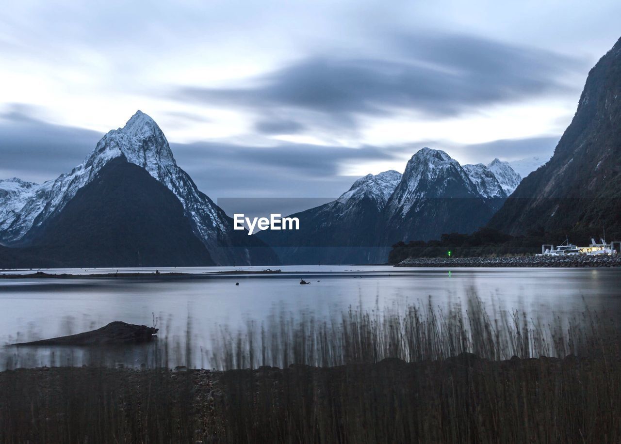 Idyllic view of milford sound against sky during winter